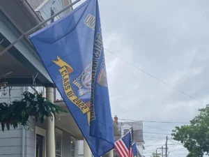 A class crest flag flying from a porch railing
