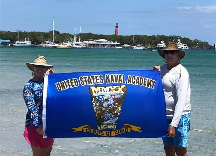 Class crest flag held up on a Florida beach