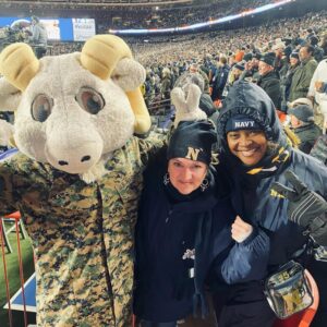 Bill the Goat mascot with club members in the stadium stands